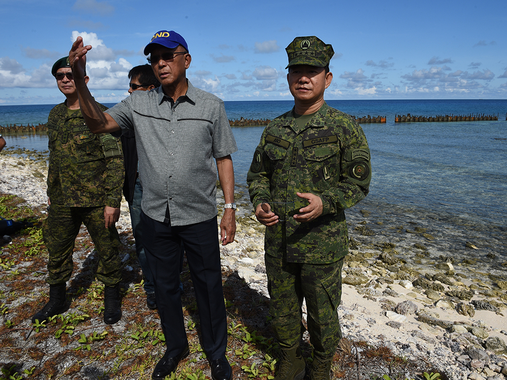 Filipino officials visit disputed isle, to build facilities