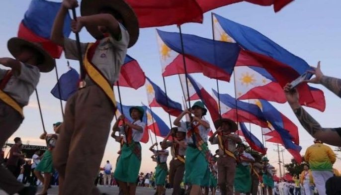 Girl scouts and boy scouts parade Philippine flags during yesterday&acirc;��s opening of the Central Visayas Regional Athletic Association (CVIRAA) Regional Meet at the South Road Properties. 