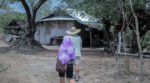 Farmer Ferdinand Manaloto walks towards the house of the Nogoy family. This house is within sight of the Aquatic Center, where water sports will be held during the 2019 SEA Games. The sports complex is also meant to be a training area for Filipino athletes.