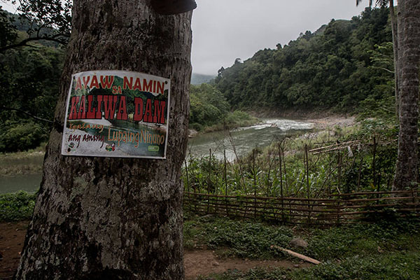 A poster saying ‘We are against Kaliwa Dam’ is posted on a tree at Queborosa village in Infanta, Quezon