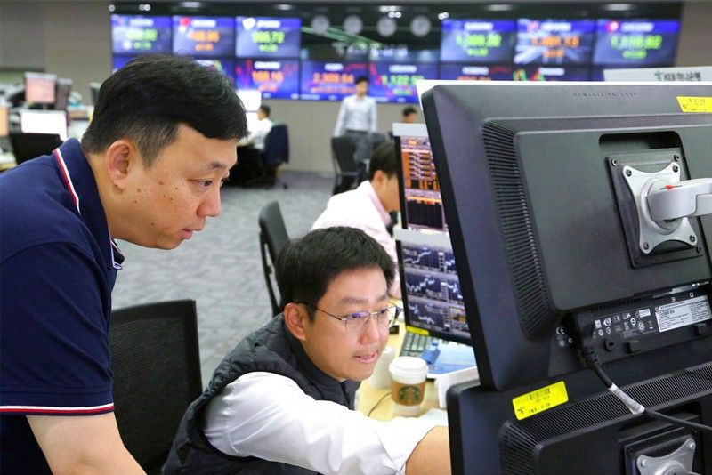 Asian shares mostly higher; Japan's Nikkei up on weak yen