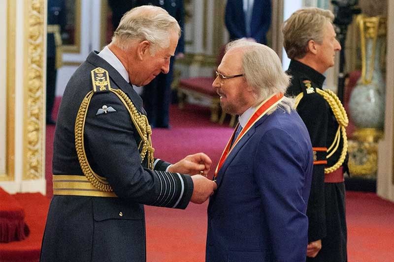 Knight fever: Bee Gees star becomes Sir Barry Gibb at palace