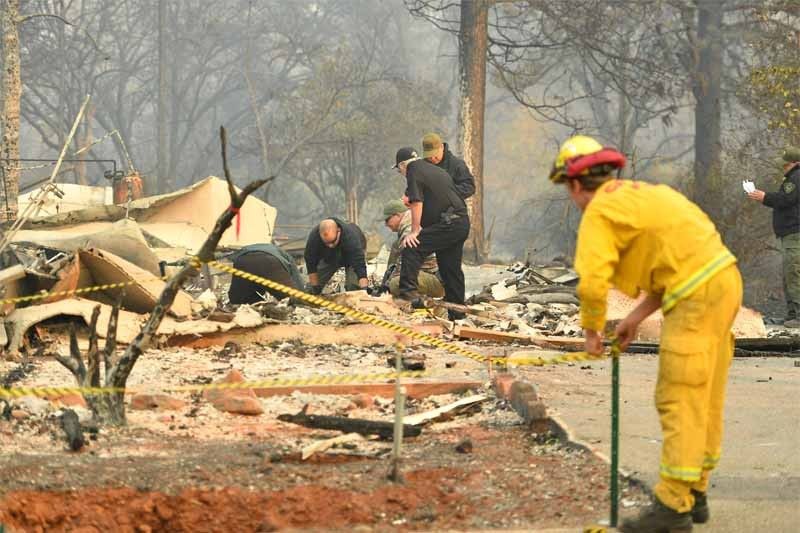 Rescue workers recover bodies in fire-hit California town
