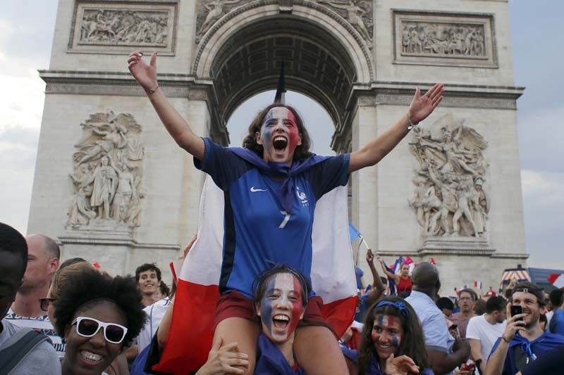 With flags, song, pride, French celebrate unifying victory