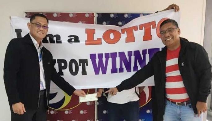 Male nurse claims half of P1.18-billion lotto jackpot