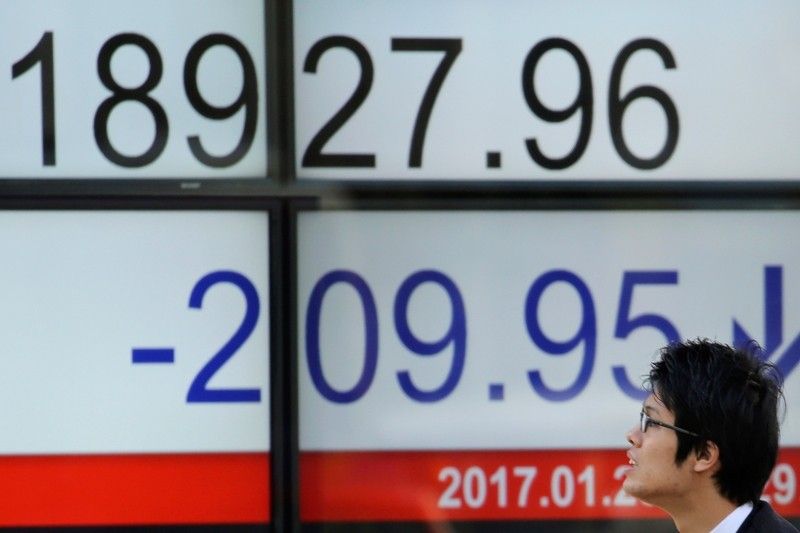 Asian shares mixed after Trump inauguration, dollar weakens