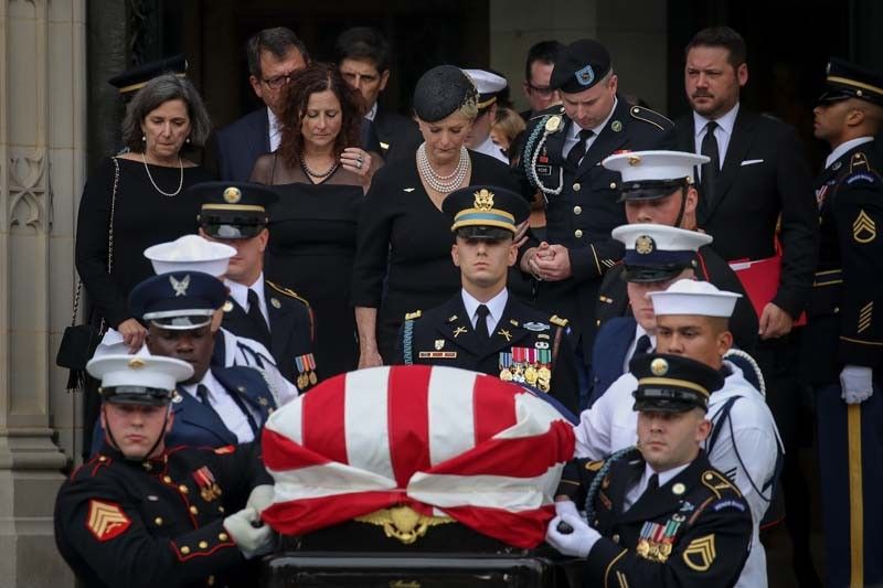 Two presidents honor McCain at funeral as Trump heads to golf club