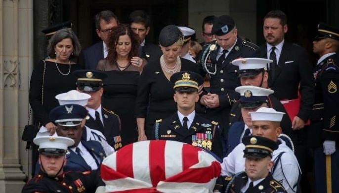 Two presidents honor McCain at funeral as Trump heads to golf club