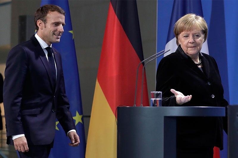 Macron, Merkel seek common approaches to Trump, euro