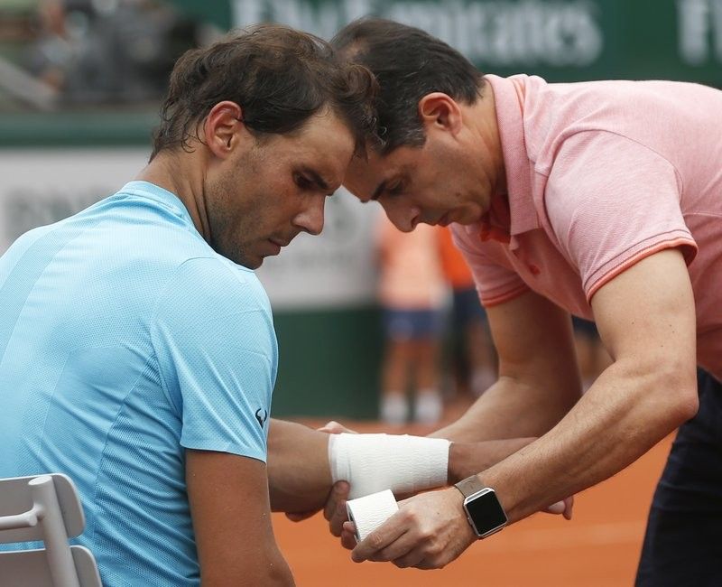 Nadal drops set, but rain suspends French Open quarterfinal