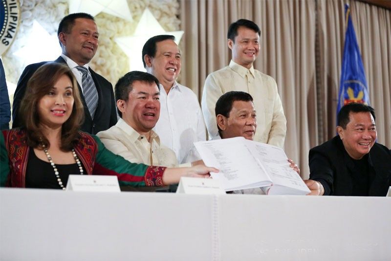 Duterte signs 2018 national budget, tax reform bill
