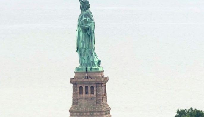 Protester scales Statue of Liberty's base, forces evacuation