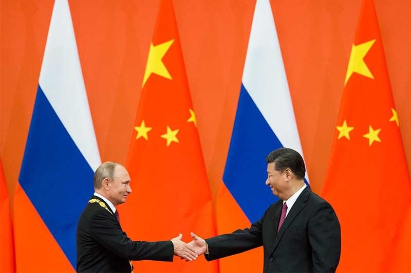 In battle for Putin's affections, cupid favors Xi over Trump