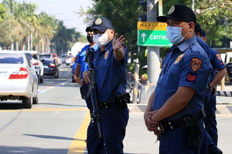 Photo shows members of the Philippine National Police deployed in Manila amid COVID-19 threat. The STAR/Edd Gumban