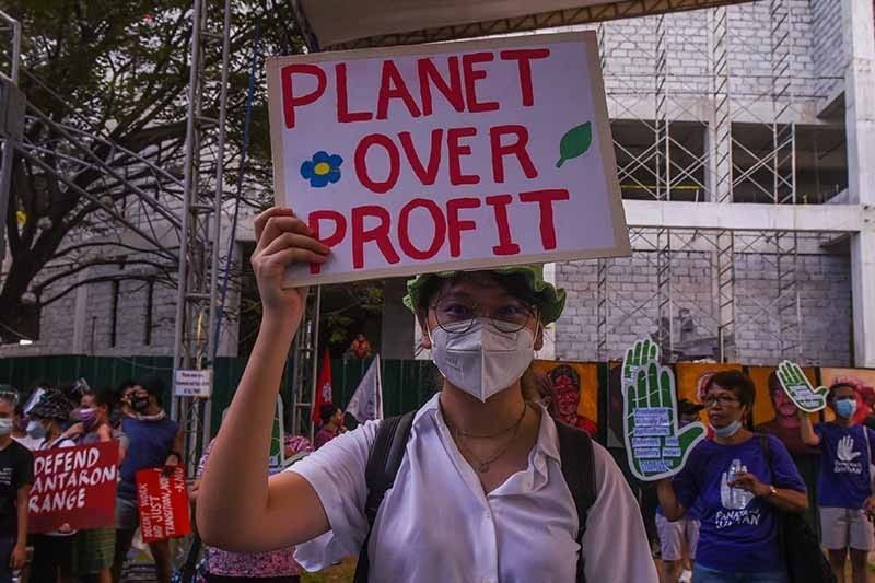 People participate in a rally during a global day of action on climate change in Manila on November 6, 2021, as world leaders attend the COP26 UN Climate Change Conference in Glasgow. AFP/Maria Tan