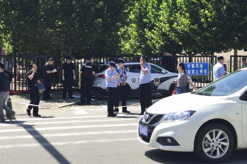 Police say man injured setting off embassy blast in China