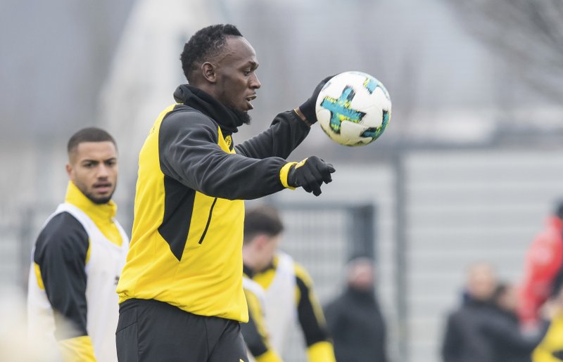 Usain Bolt delights fans by scoring in Dortmund training