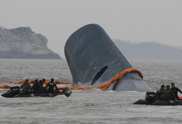Divers pumping air into submerged SKorean ship