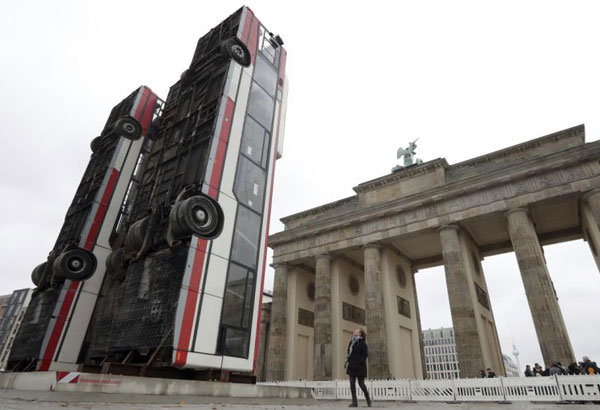 Buses upended in Berlin evoke suffering of Syrian refugees