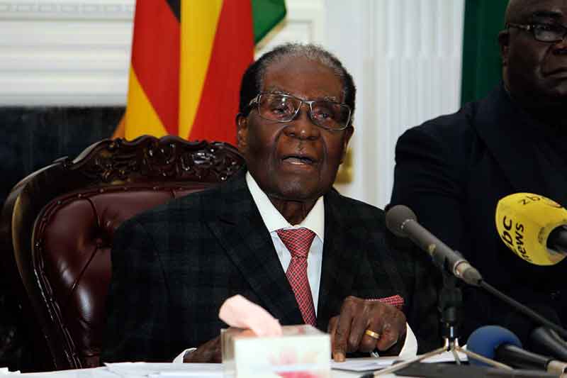Zimbabwe president defies mounting pressure to leave office
