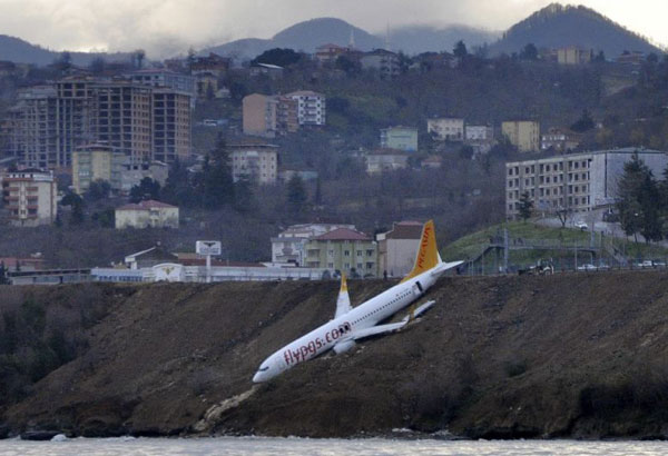 Plane dangles off cliff after skidding off runway in Turkey