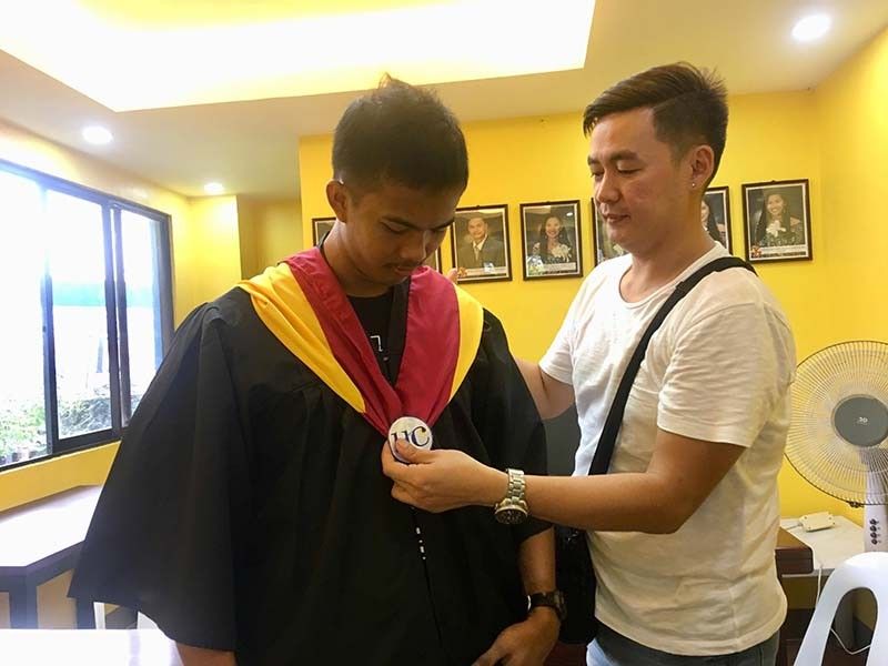 Student by day, tanod by night; Janryl Tan gets diploma with flying colors