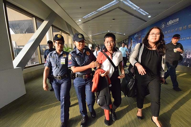 Fresh off plane, Rappler's Ressa booked by Pasig police