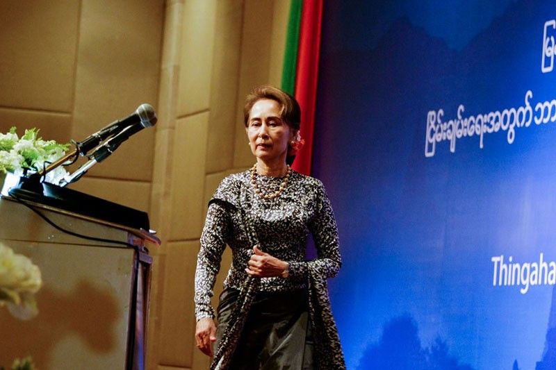 Suu Kyi tries to save face with Myanmar reporters' release