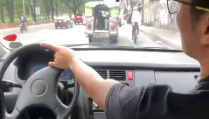 LTO revokes license of man for driving from passenger seat, smoking inside car