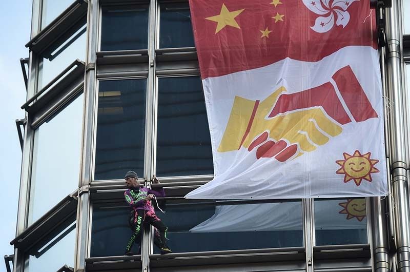 'French Spiderman' scales Hong Kong skyscraper with 'peace banner'