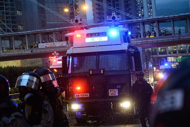 Hong Kong police say violent protesters forced use of water cannon, warning shot