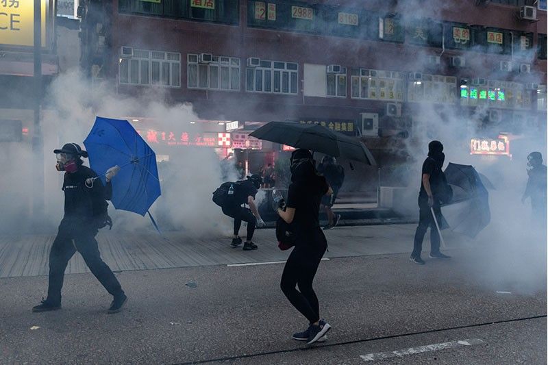 Tear gas and water cannon as Hong Kong crowds defy rally ban