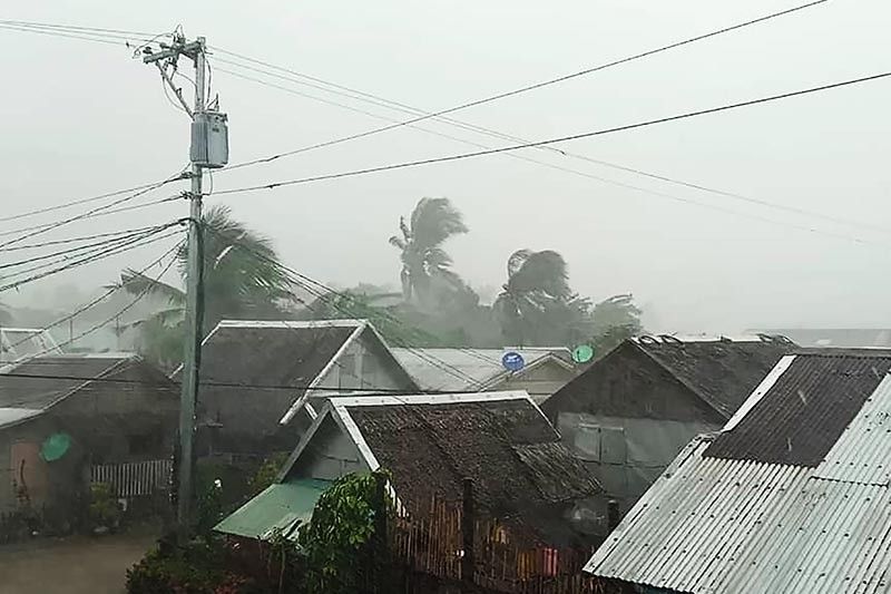 Bringing heavy rains and violent winds, Typhoon Tisoy tears through southern Luzon