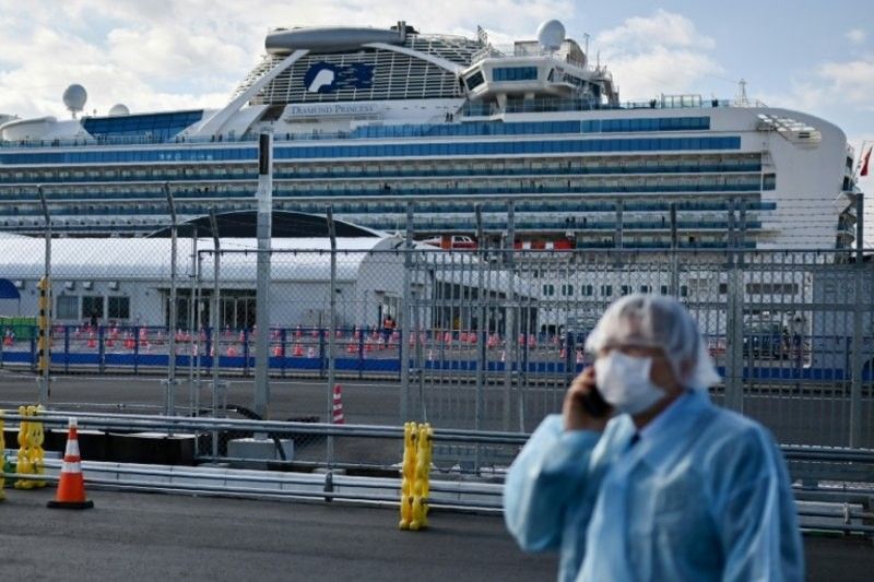 China sees drop in new virus cases, two Japan cruise passengers die