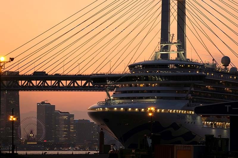 Dozens allowed off Japan virus-hit ship have 'symptoms': minister