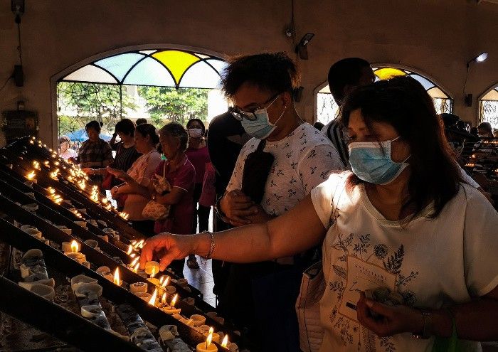 Filipino Catholics wearing masks to protect against COVID-19