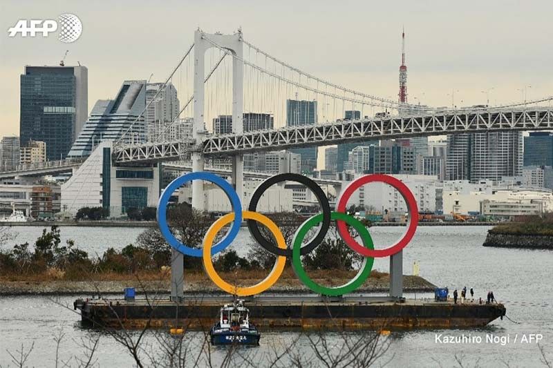 Japan PM brushes off cancellation report, 'determined' to hold Olympics