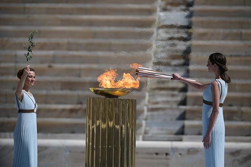 Japan welcomes Olympic flame as doubts swirl over Games