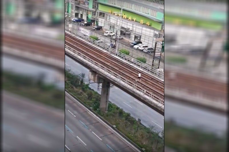 Woman jogs along empty MRT-3 track