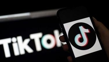 In this file photo taken on April 13, 2020, the social media application TikTok logo is displayed on the screen of an iPhone in Arlington, Virginia Former Disney executive Kevin Mayer will become the head of TikTok and chief operating officer of the popular video app's parent company, the group announced on May 18, 2020. 