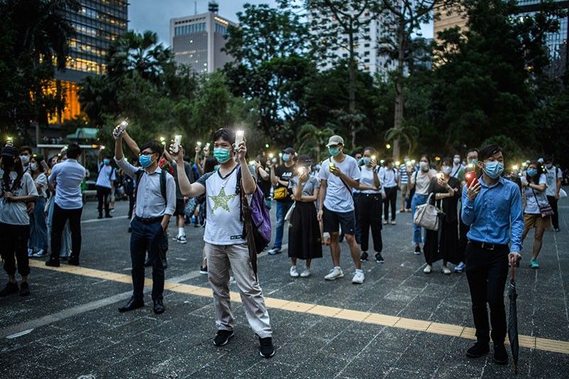 Anniversary protests as Hong Kong democracy movement faces triple threat