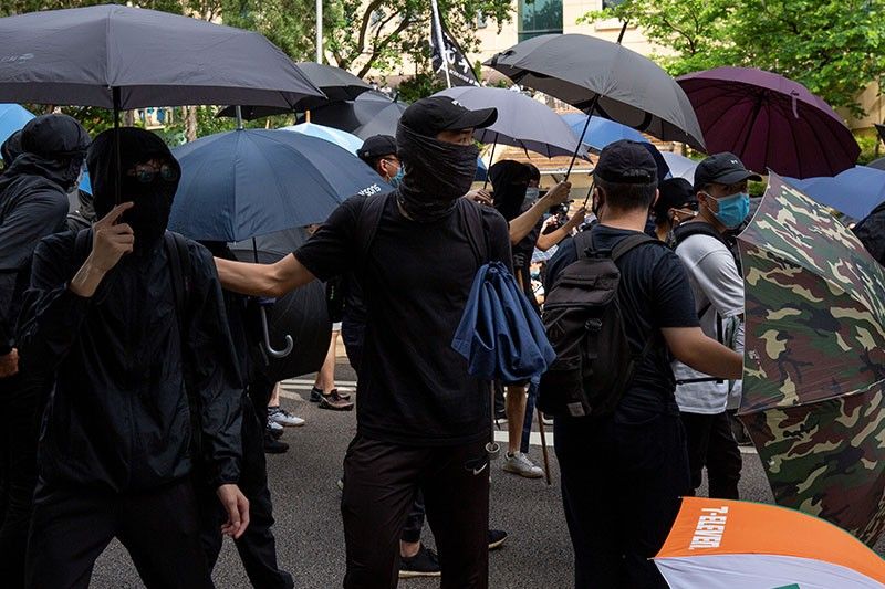 Hong Kong makes first security law arrests as thousands defy protest ban