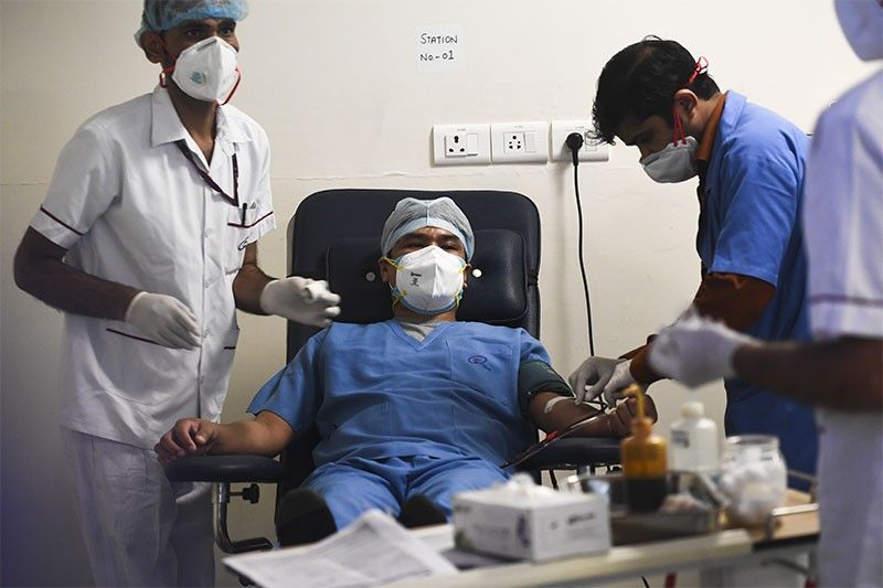 Virus pushes US hospitals to the brink, India hits record new cases