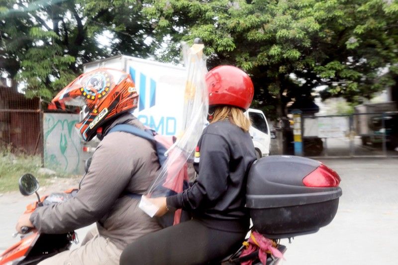 Motorcycle back-riding in areas under MECQ allowed for essential workers