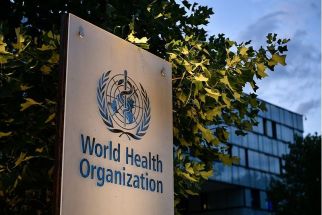 A photo taken in the late hours of August 17, 2020 shows a sign of the World Health Organization (WHO) at their headquarters in Geneva amid the COVID-19 outbreak, caused by the novel coronavirus. 