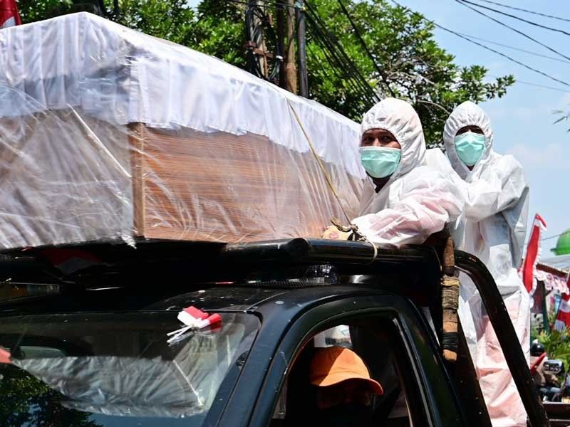 Indonesia stages coffin parade as reminder of virus threat