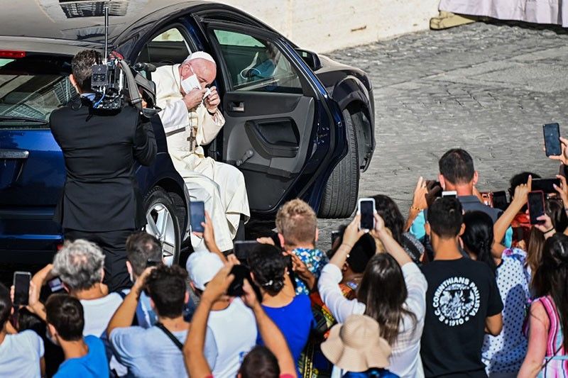 Pope Francis sports a face mask for the first time in public