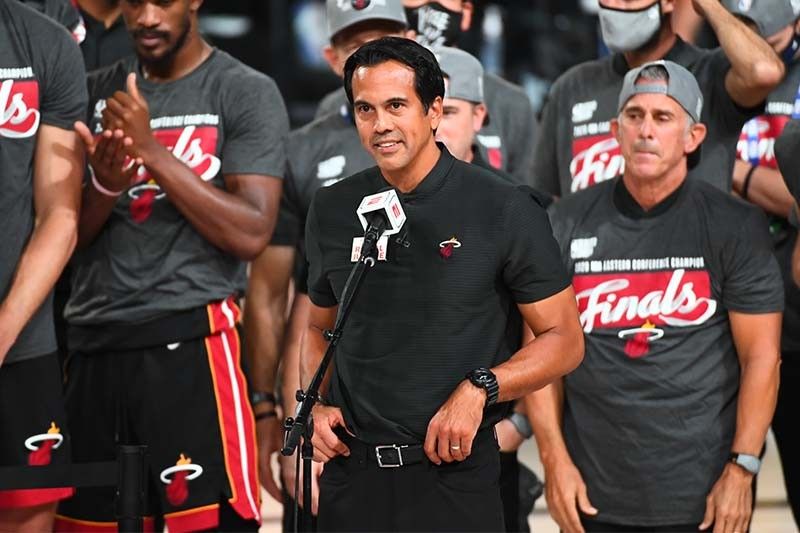 Miami Heat head coach Erik Spoelstra, right, presents a 2011-12