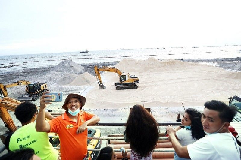 DENR: Dolomite in Manila Bay not washed out, only covered by gray sand