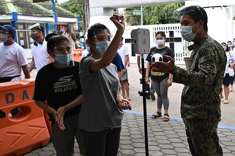 Philippines 'not yet out of the woods' of pandemic, DOH says